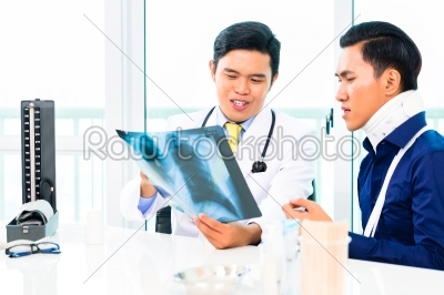 Asian doctor showing X-ray photography