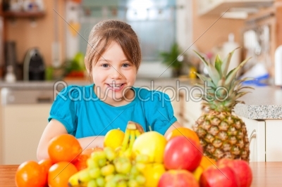 Child with lots of fruits for breakfast food