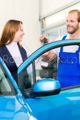 customer and car mechanic in auto workshop