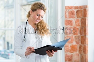 Doctor in clinic reading a file