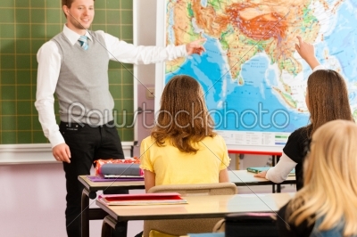 Education - Teacher with pupil in school teaching