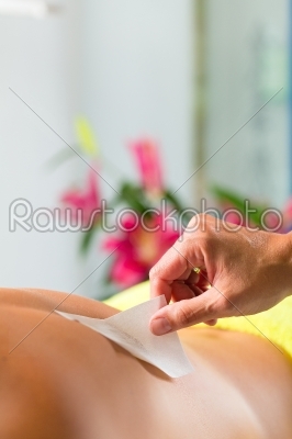 Man in Spa getting back waxed for hair removal