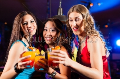 People drinking cocktails in bar or club