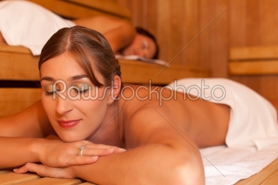Two female friends in a sauna