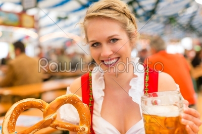 Woman with traditional Bavarian clothes or dirndl in beer tent