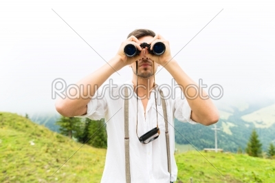 Alps - Man on mountains with field glasses 