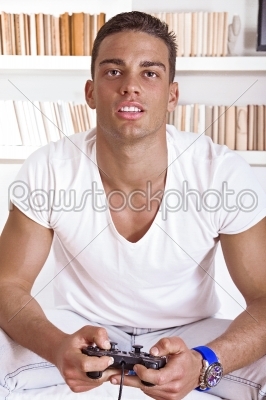 attractive guy concentrating while playing video games