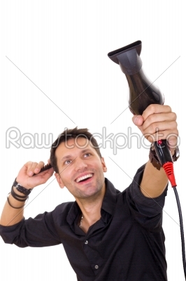 attractive hairdresser using blow dryer and comb