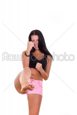 beautiful girl giving a kick with a leg 