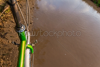 Bicycle ride through muddy dirt road
