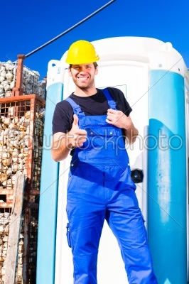 builder using mobile toilet on site