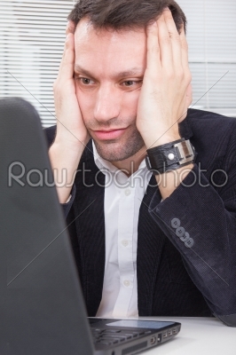 business man looking at screen laptop computer with a shocked up