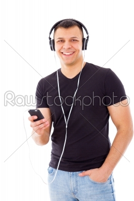 casual man with hand in pocket listening to music on headphones