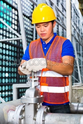Chinese Technician working on valve