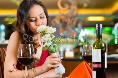 Chinese woman waiting in restaurant for date 