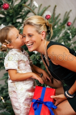 Christmas - child kissing her Mother