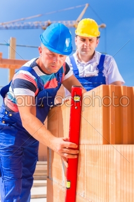 construction site workers checking  building shell