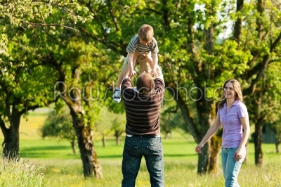 Family having a walk outdoors in summer