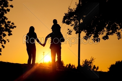 Family having walk at sunset