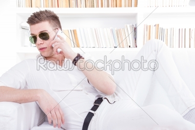 fashion man wearing sunglasses talking on the phone relaxed indo