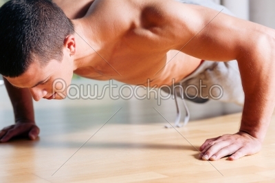 Man exercising  in gym - push ups