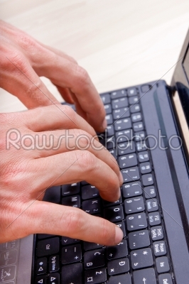 man_qt_s hands typing on laptop keyboard