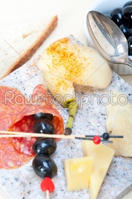 mix cold cut on a stone with fresh pears