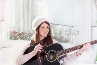 pretty girl playing the guitar