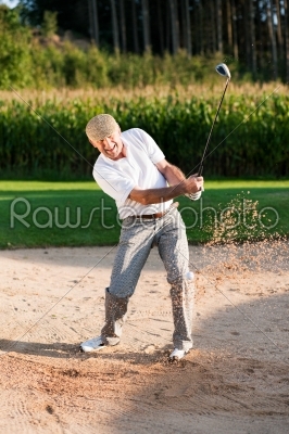 Senior golf player in sand trap