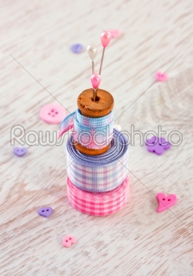 Sewing items with a check fabrics, buttons, thread and pins
